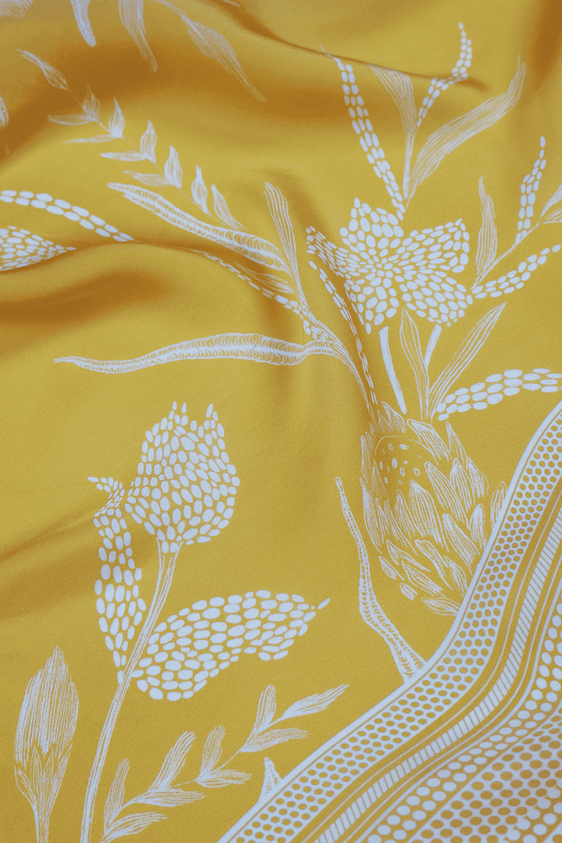 Close-up of yellow scarf with white floral pattern