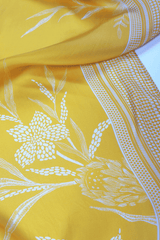 Yellow scarf with white floral and geometric patterns