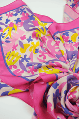 Colorful scarf with abstract patterns draped on a white background